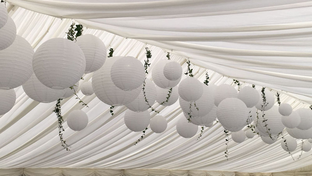 Hanging lanterns and ivy at wedding