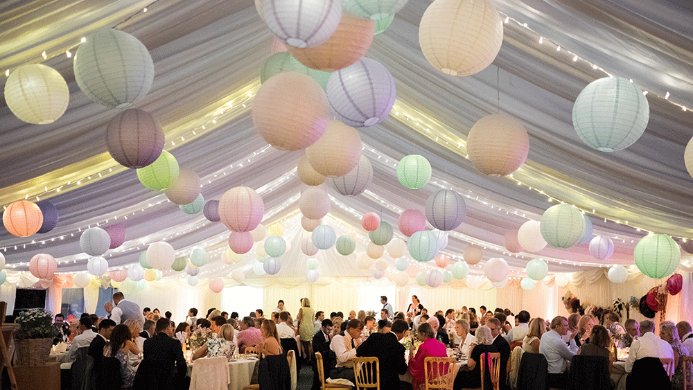 Pastel paper lanterns create a festival themed wedding