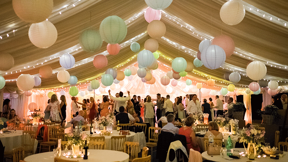 Pastel paper lanterns create a festival themed wedding