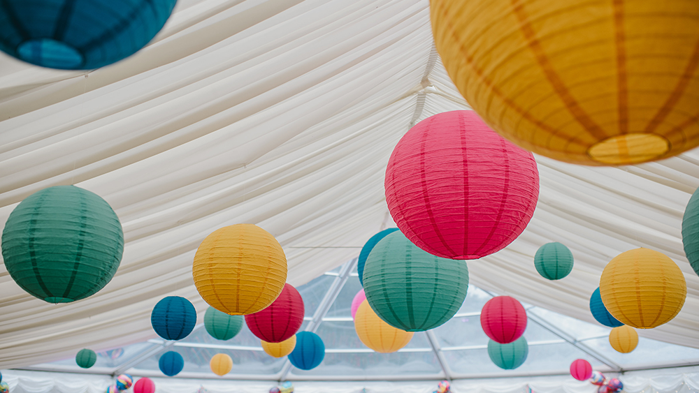 Garden festival themed coloured lanterns dress Sussex Bell End Tent