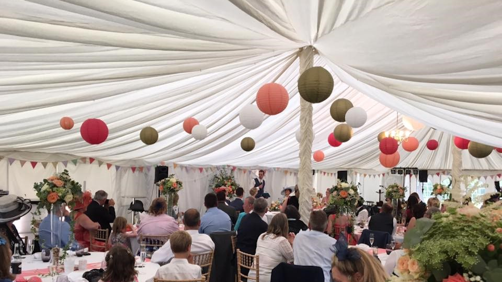 Coral and Gold Lanterns Brighten a Traditional Pole Tent