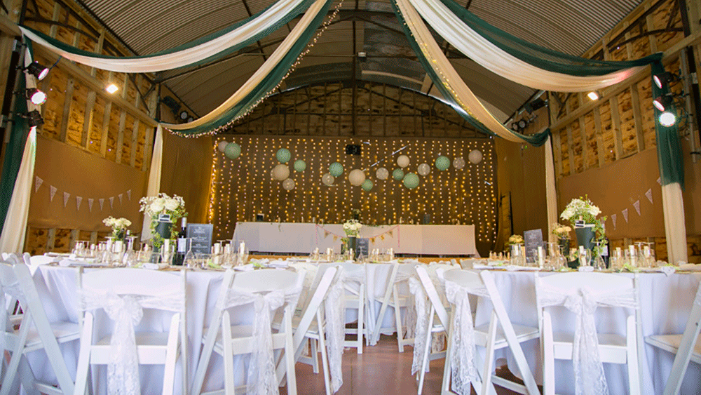 Rustic Barn Transformed using Soft Coloured Hanging Lanterns