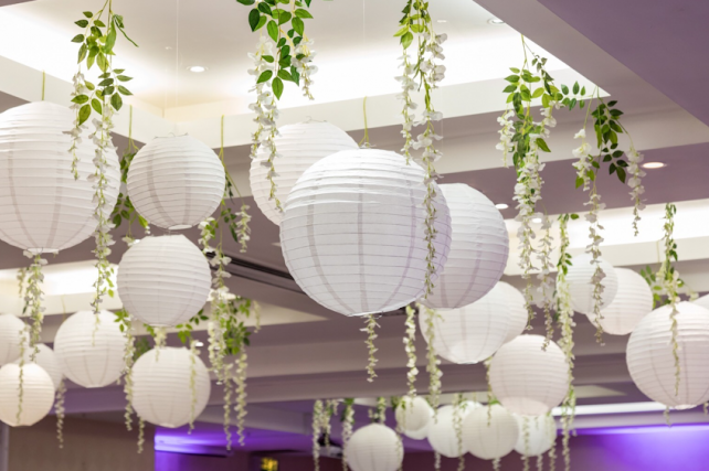 White wedding lanterns interspersed with wisteria