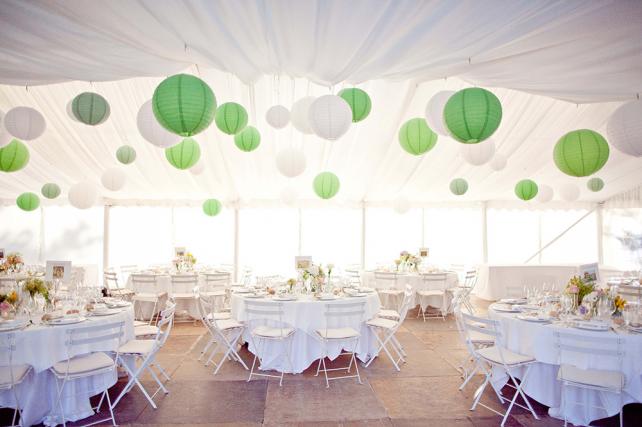 Green and white paper lanterns in a wedding marquee