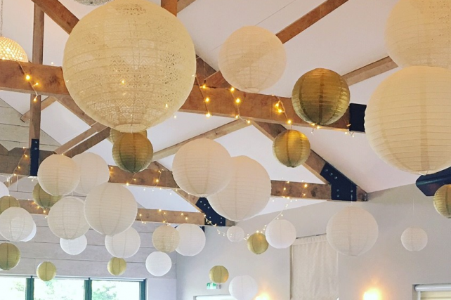 Gold and lace lanterns decorate The Boathouse