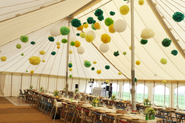 Canvas marquee decorated with tissue pompoms