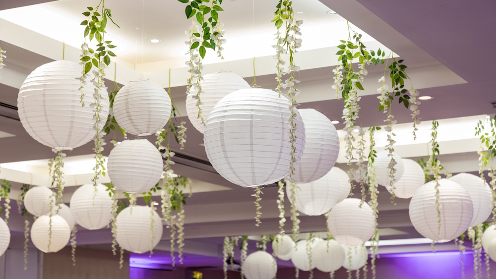 White wedding lanterns interspersed with wisteria