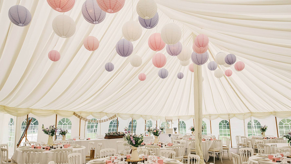 Rustic hanging lanterns in traditonal marquee