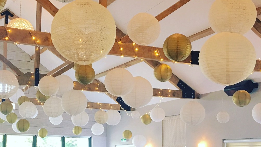 Gold and lace lanterns decorate The Boathouse