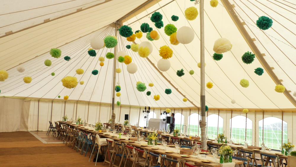 Canvas marquee decorated with tissue pompoms